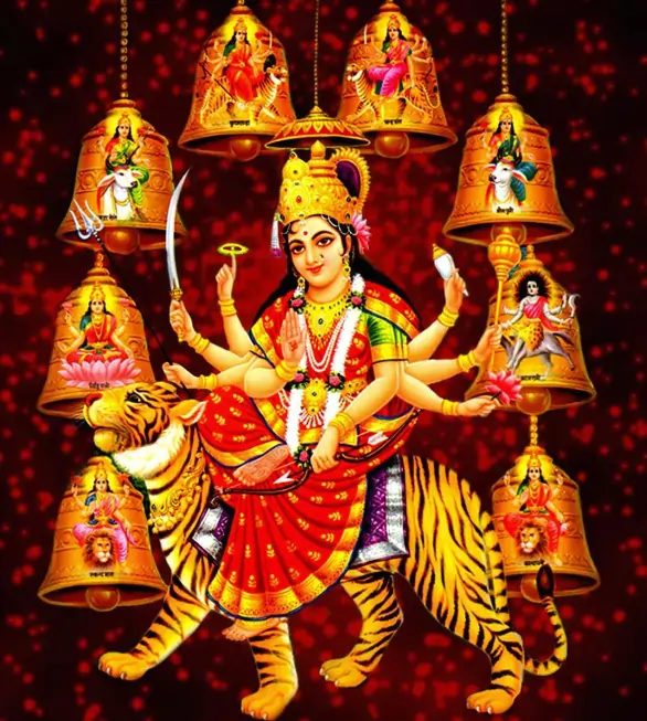Multi-armed Hindu goddess riding a tiger, surrounded by golden temple bells featuring devotional deity images.